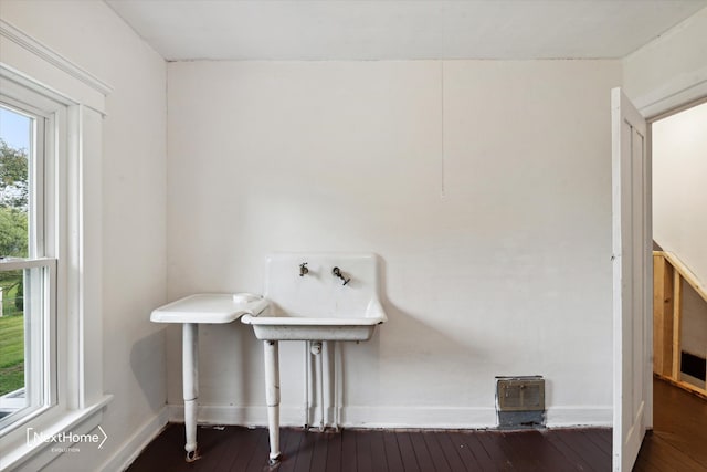 bathroom featuring wood-type flooring and baseboards