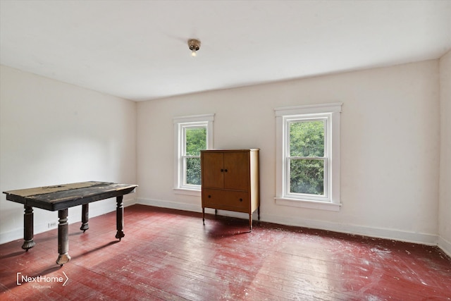 interior space featuring wood-type flooring and baseboards