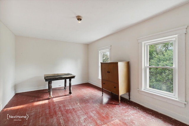 interior space featuring wood-type flooring and baseboards