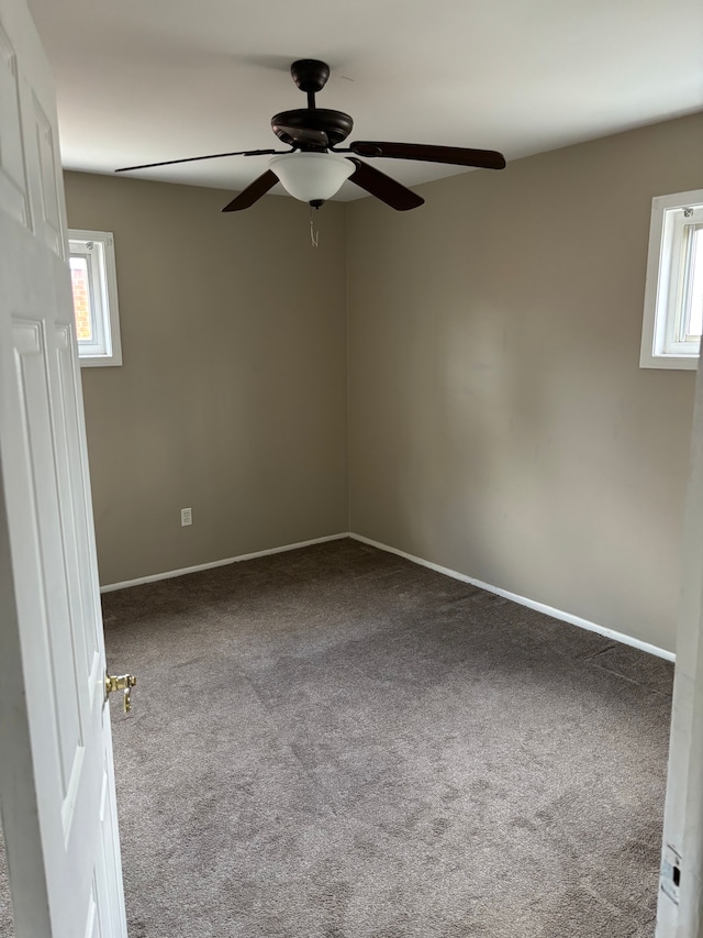 carpeted spare room with a healthy amount of sunlight and baseboards