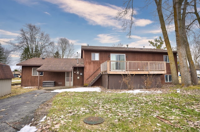 rear view of property featuring stairs