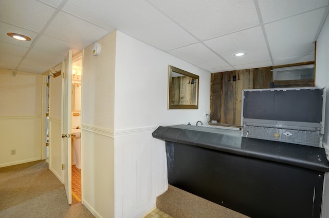 bar with wooden walls, a wainscoted wall, carpet flooring, a paneled ceiling, and recessed lighting