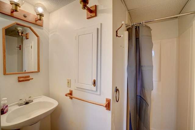 bathroom featuring curtained shower and a sink