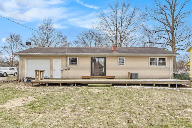 rear view of house with a deck, central AC, a lawn, and a garage