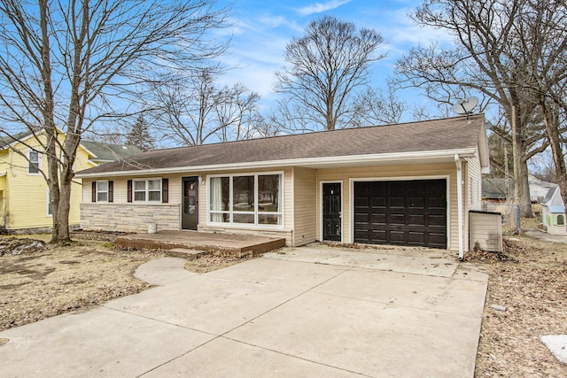 ranch-style home with an attached garage, stone siding, and concrete driveway