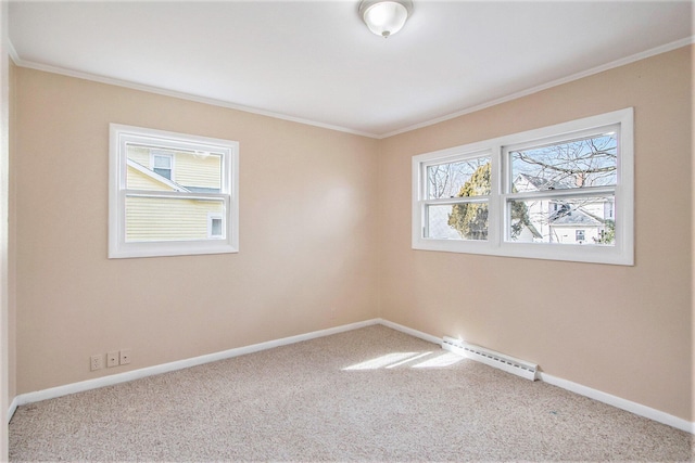 unfurnished room featuring a baseboard heating unit, carpet, ornamental molding, and baseboards