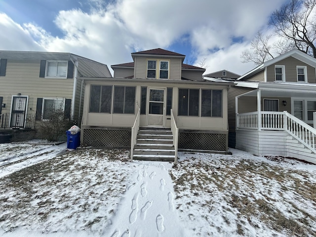 view of front of home featuring a sunroom