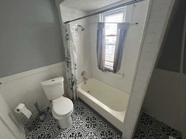 full bath with shower / bath combination with curtain, tile patterned flooring, and toilet