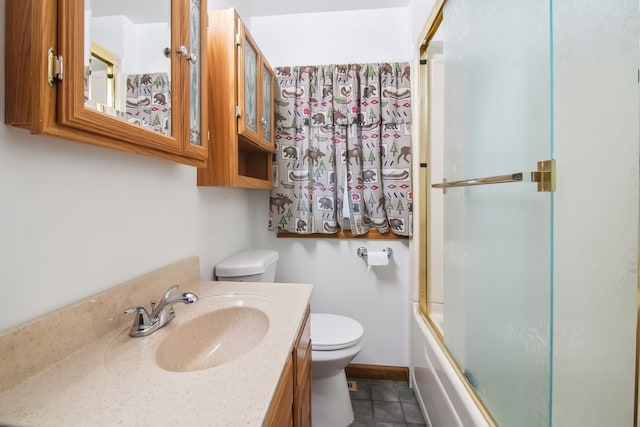 bathroom with bath / shower combo with glass door, toilet, vanity, baseboards, and tile patterned floors