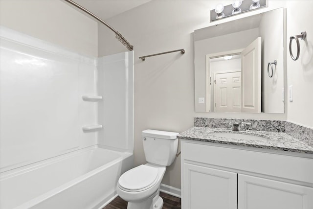 bathroom with shower / washtub combination, toilet, vanity, wood finished floors, and baseboards