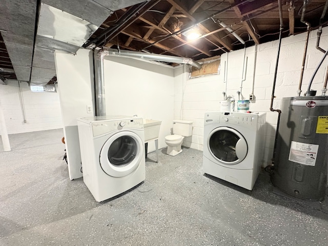 clothes washing area with laundry area, water heater, and separate washer and dryer