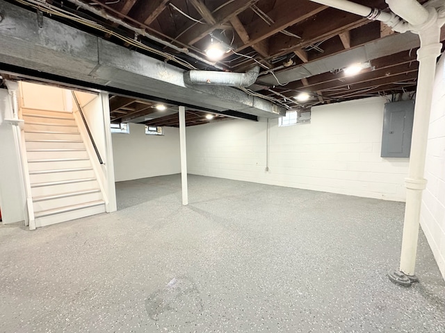 basement with electric panel and stairway