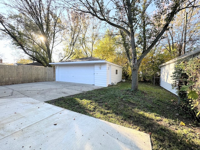 detached garage featuring fence