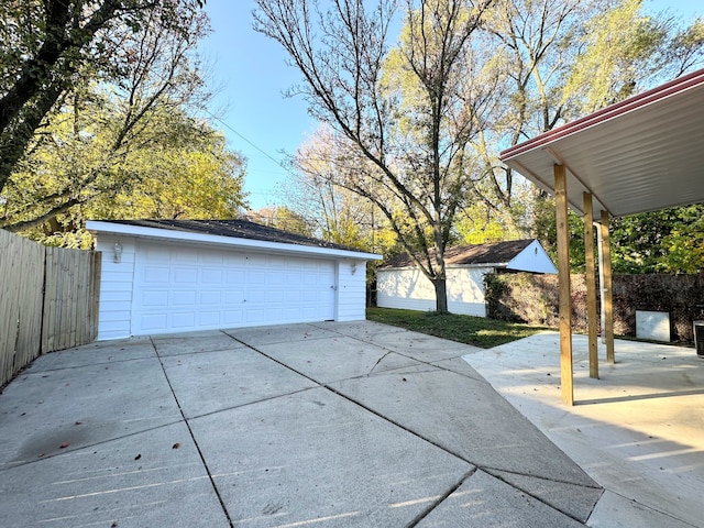 detached garage featuring fence