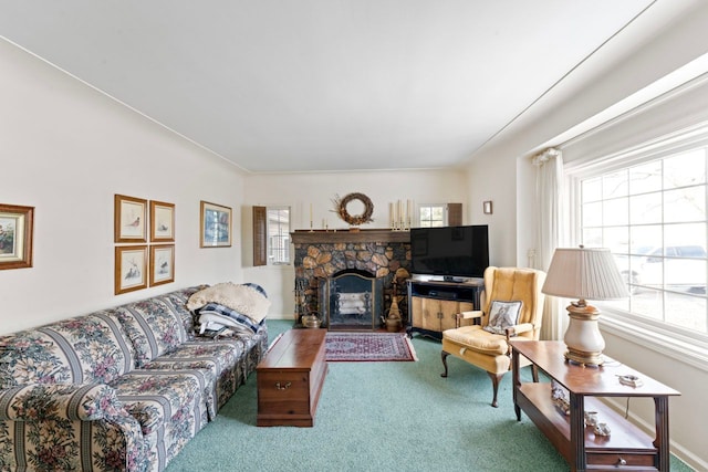 living area featuring carpet and a fireplace