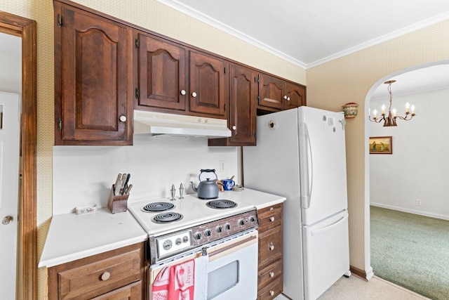 kitchen featuring arched walkways, under cabinet range hood, white appliances, light countertops, and wallpapered walls