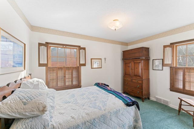 carpeted bedroom featuring visible vents and baseboards