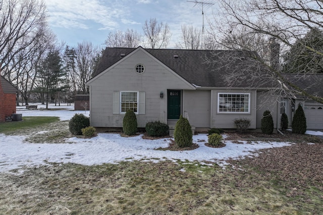 view of front facade with roof with shingles