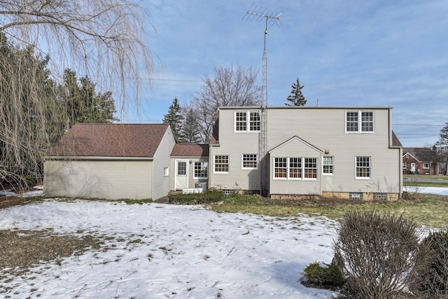 view of snow covered rear of property