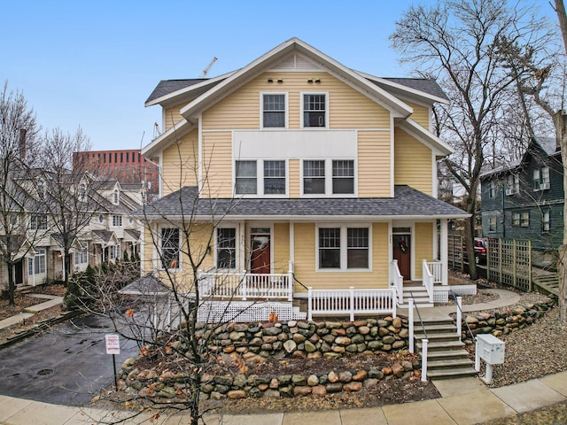 view of front of home featuring a porch and roof with shingles