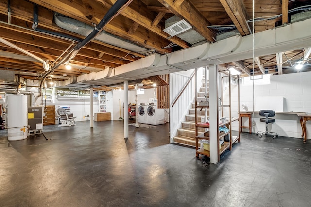 unfinished basement featuring concrete block wall, water heater, visible vents, independent washer and dryer, and stairs