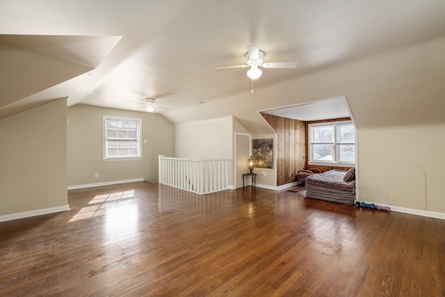 bonus room featuring lofted ceiling, ceiling fan, baseboards, and wood finished floors