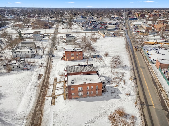 snowy aerial view with a residential view