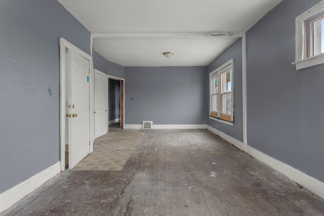 spare room featuring visible vents and baseboards