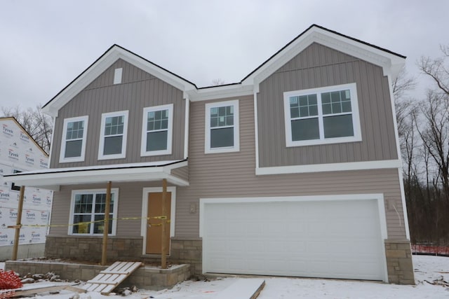 view of front of property featuring board and batten siding, stone siding, and an attached garage