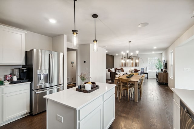 kitchen with stainless steel appliances, open floor plan, dark wood-style floors, and a center island