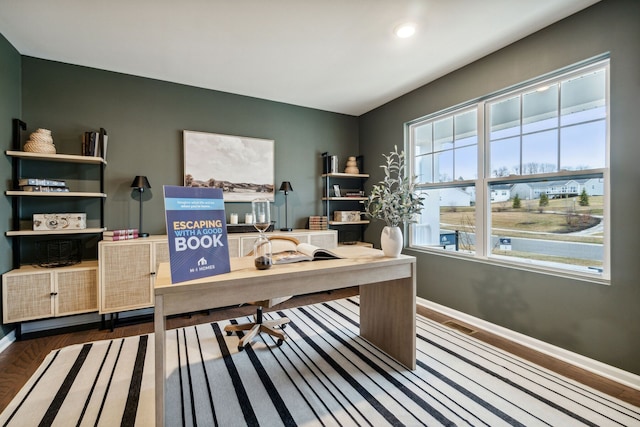 office area with baseboards and wood finished floors