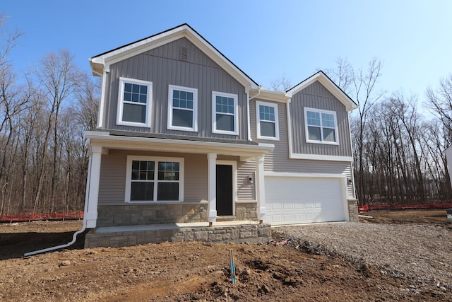 view of front of property with stone siding, dirt driveway, board and batten siding, and an attached garage