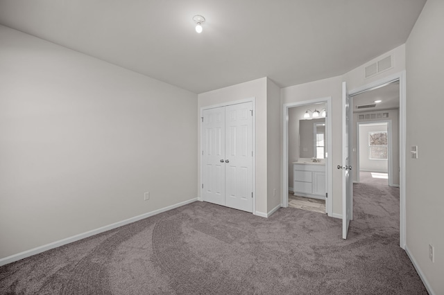 4278 Oak St, Grand Blanc, MI 48439 - unfurnished bedroom featuring a closet, baseboards, carpet flooring, and visible vents