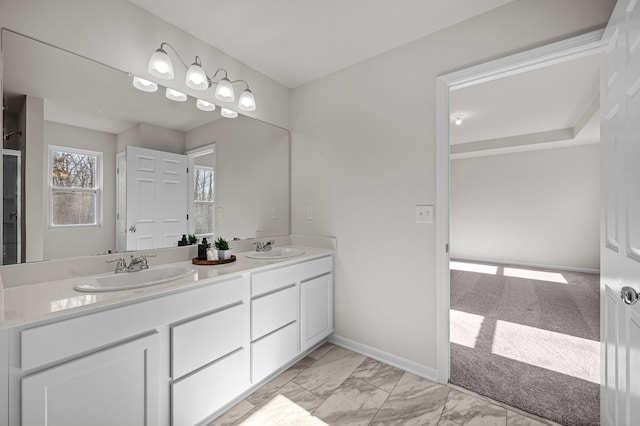 4278 Oak St, Grand Blanc, MI 48439 - bathroom with double vanity, a sink, baseboards, and marble finish floor