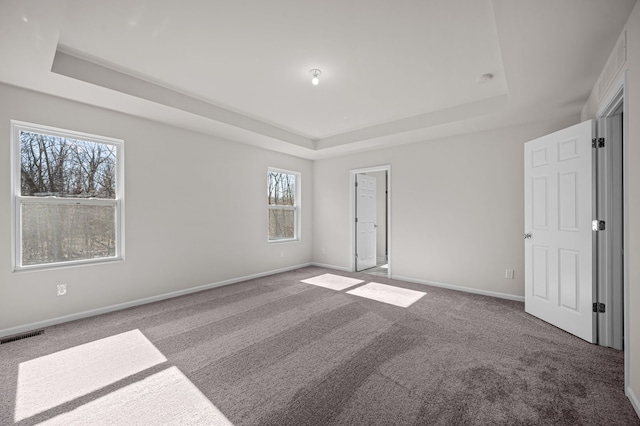 4278 Oak St, Grand Blanc, MI 48439 - unfurnished bedroom with carpet flooring, baseboards, visible vents, and a raised ceiling