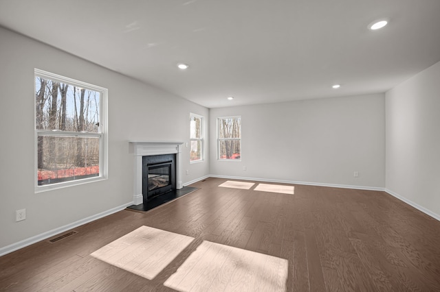 4278 Oak St, Grand Blanc, MI 48439 - unfurnished living room with visible vents, recessed lighting, dark wood-style floors, and a high end fireplace