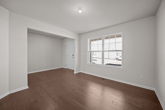 4278 Oak St, Grand Blanc, MI 48439 - spare room with baseboards, dark wood finished floors, and visible vents