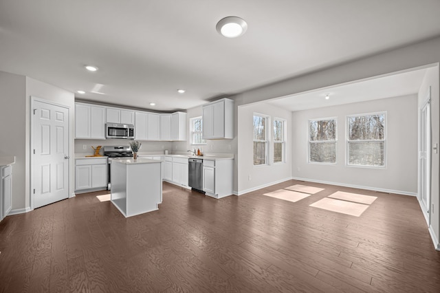 4278 Oak St, Grand Blanc, MI 48439 - kitchen featuring baseboards, open floor plan, dark wood-type flooring, light countertops, and stainless steel appliances