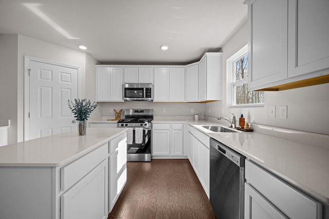 4278 Oak St, Grand Blanc, MI 48439 - kitchen featuring light countertops, white cabinetry, a sink, dark wood finished floors, and appliances with stainless steel finishes