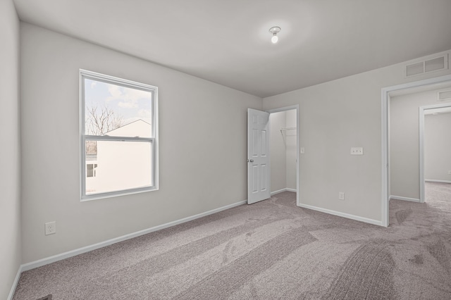 4278 Oak St, Grand Blanc, MI 48439 - unfurnished bedroom with baseboards, visible vents, a spacious closet, and carpet