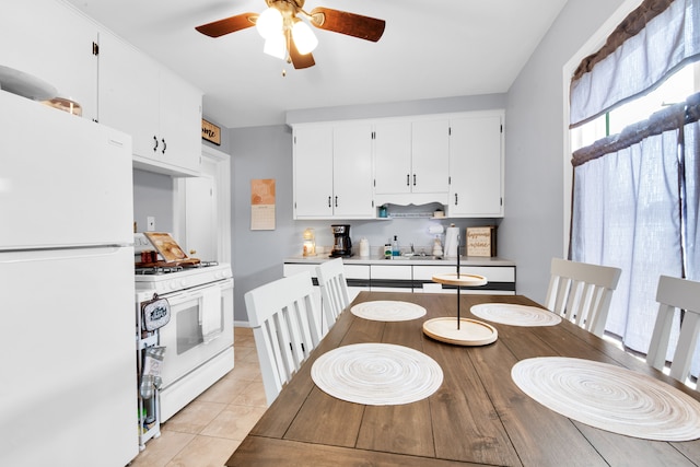 dining area with light tile patterned floors and a ceiling fan