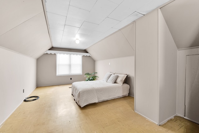 bedroom with lofted ceiling and tile patterned floors