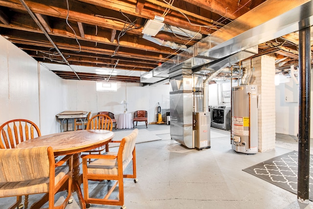 below grade area featuring water heater, washer / clothes dryer, and heating unit