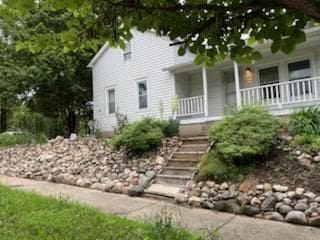 view of front facade featuring stairs and a porch