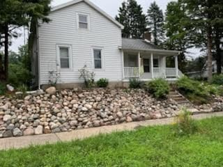 back of property with a porch