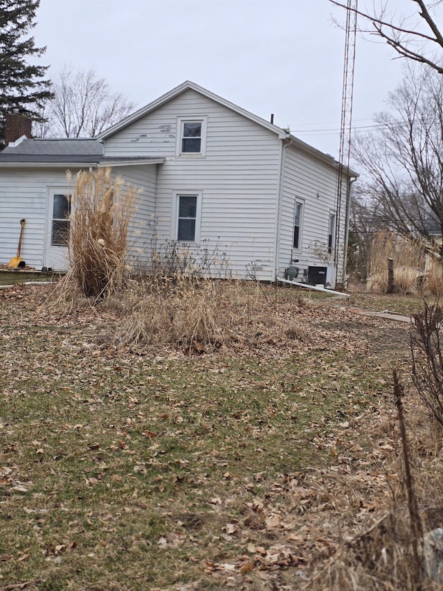 view of property exterior featuring a chimney