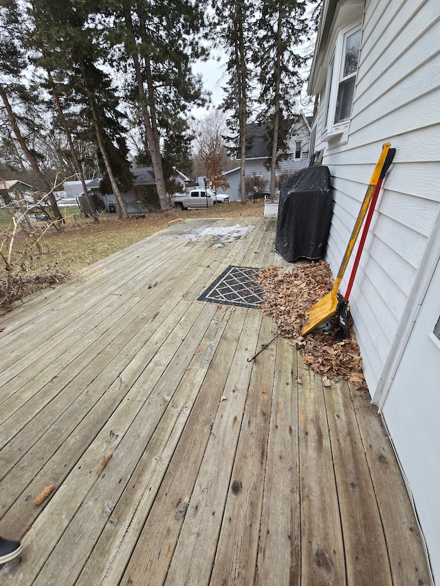 wooden deck with a grill