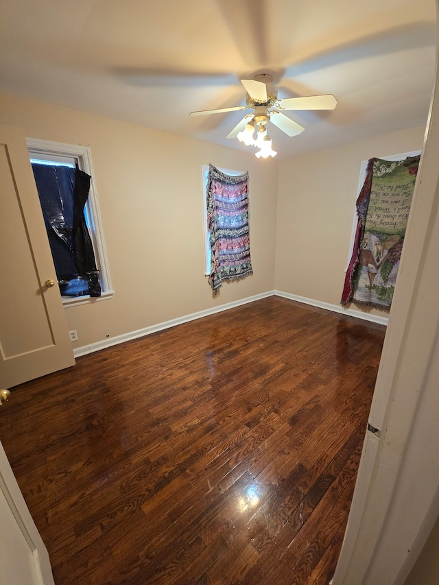 unfurnished bedroom featuring a ceiling fan, baseboards, and wood finished floors