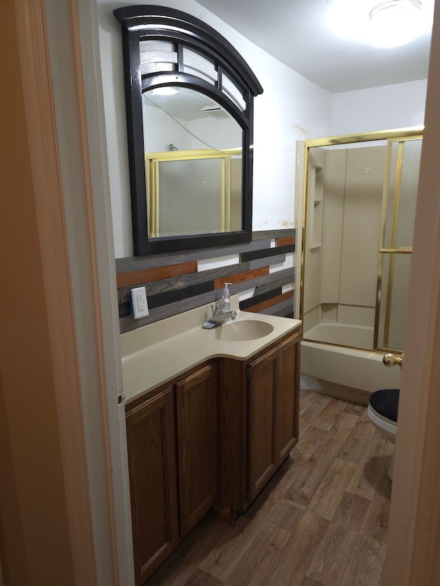 full bathroom with shower / bath combination with glass door, wood finished floors, and vanity