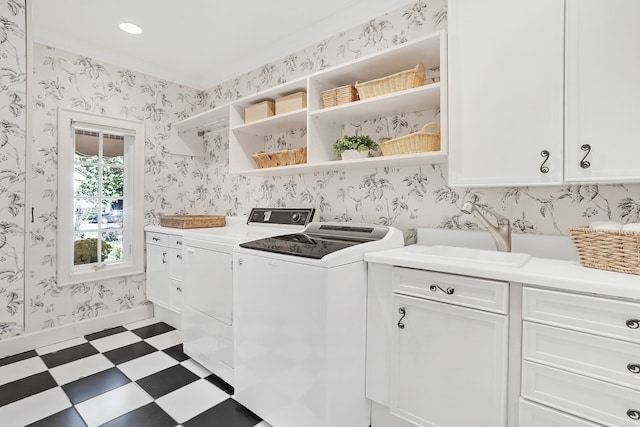 washroom with wallpapered walls, washer and clothes dryer, cabinet space, and tile patterned floors